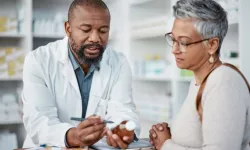 Pharmacy, black man and woman with healthcare medicine and conversation for instructions.
