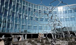Photo of Myogenica headquarters. A glass and mirror building facade