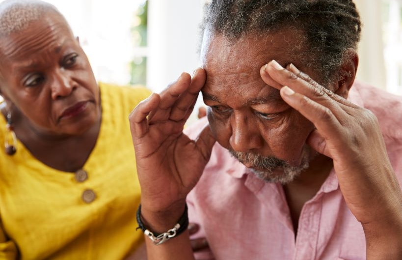 Senior Woman Comforting Man With Depression At Home