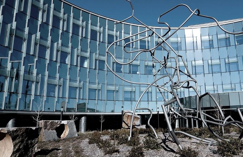 Photo of Myogenica headquarters. A glass and mirror building facade